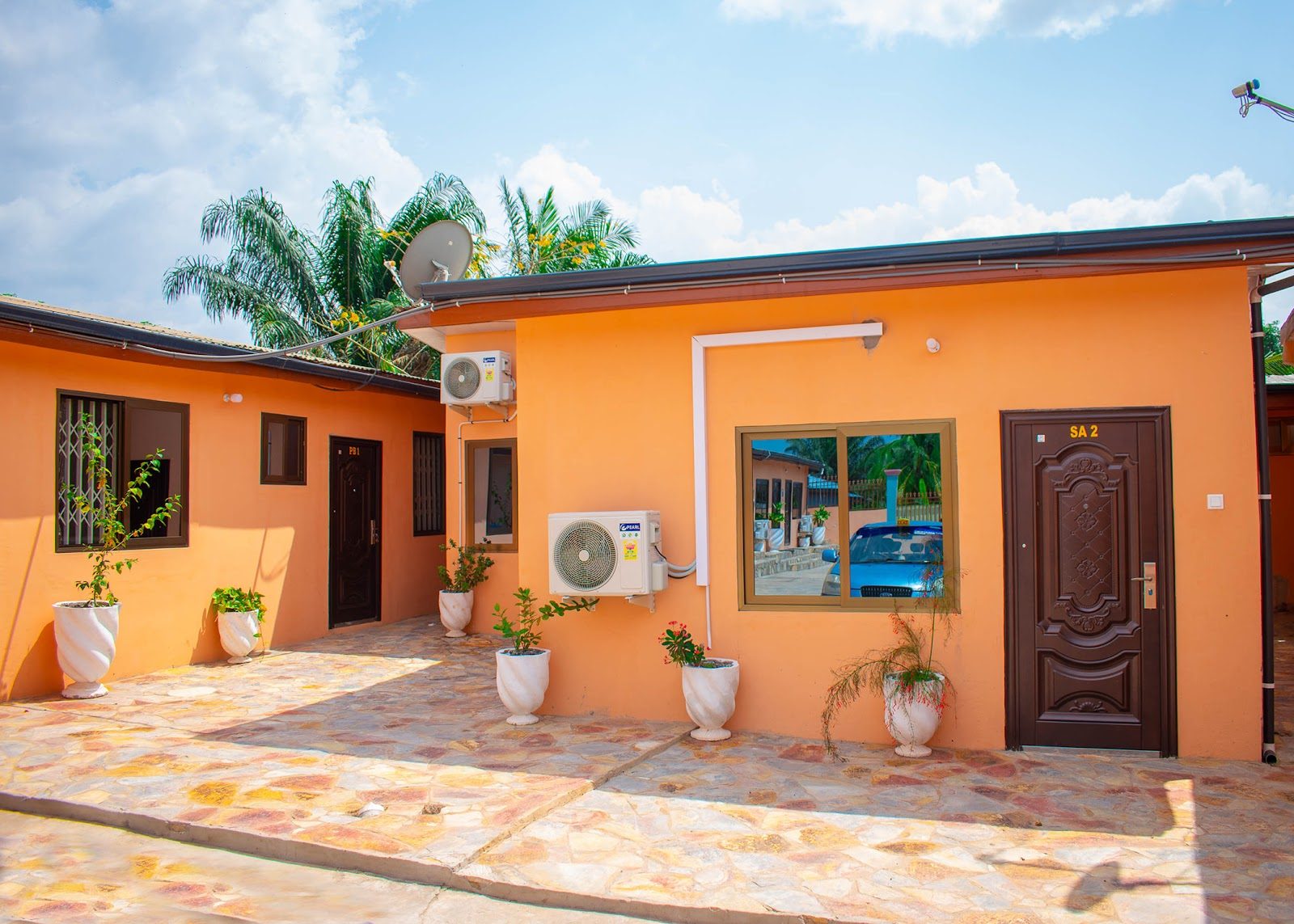 Sunlit courtyard and rooms at Bright Hotel and Suites